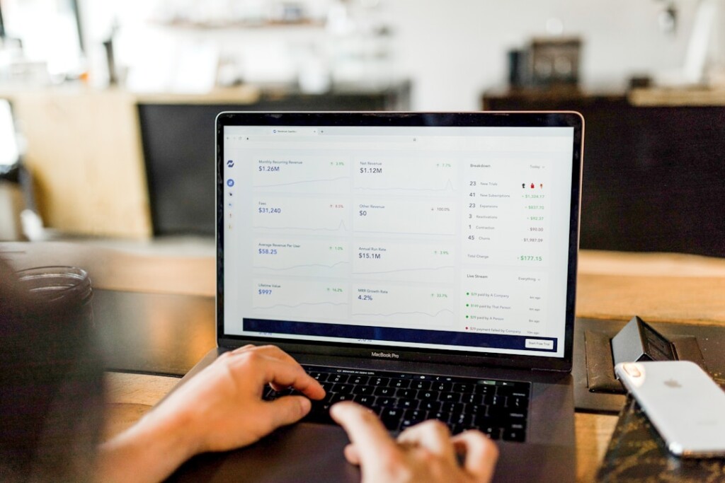 Marketing professional reviewing analytics on a laptop after implementing a customer segmentation strategy